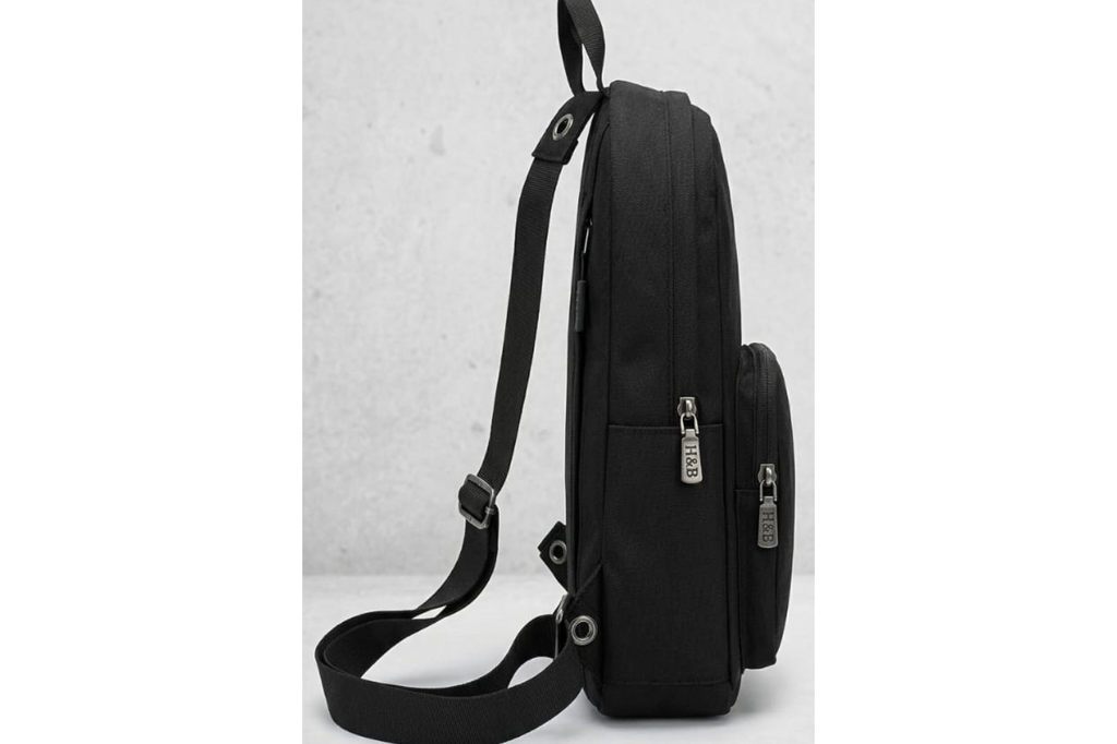 Black bag with a strap on a light gray background