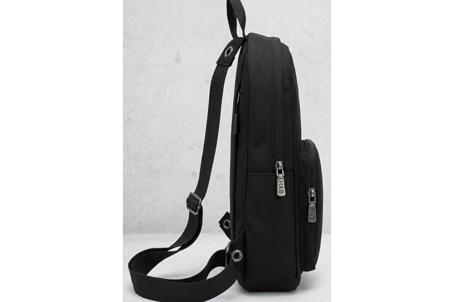 Black bag with a strap on a light gray background